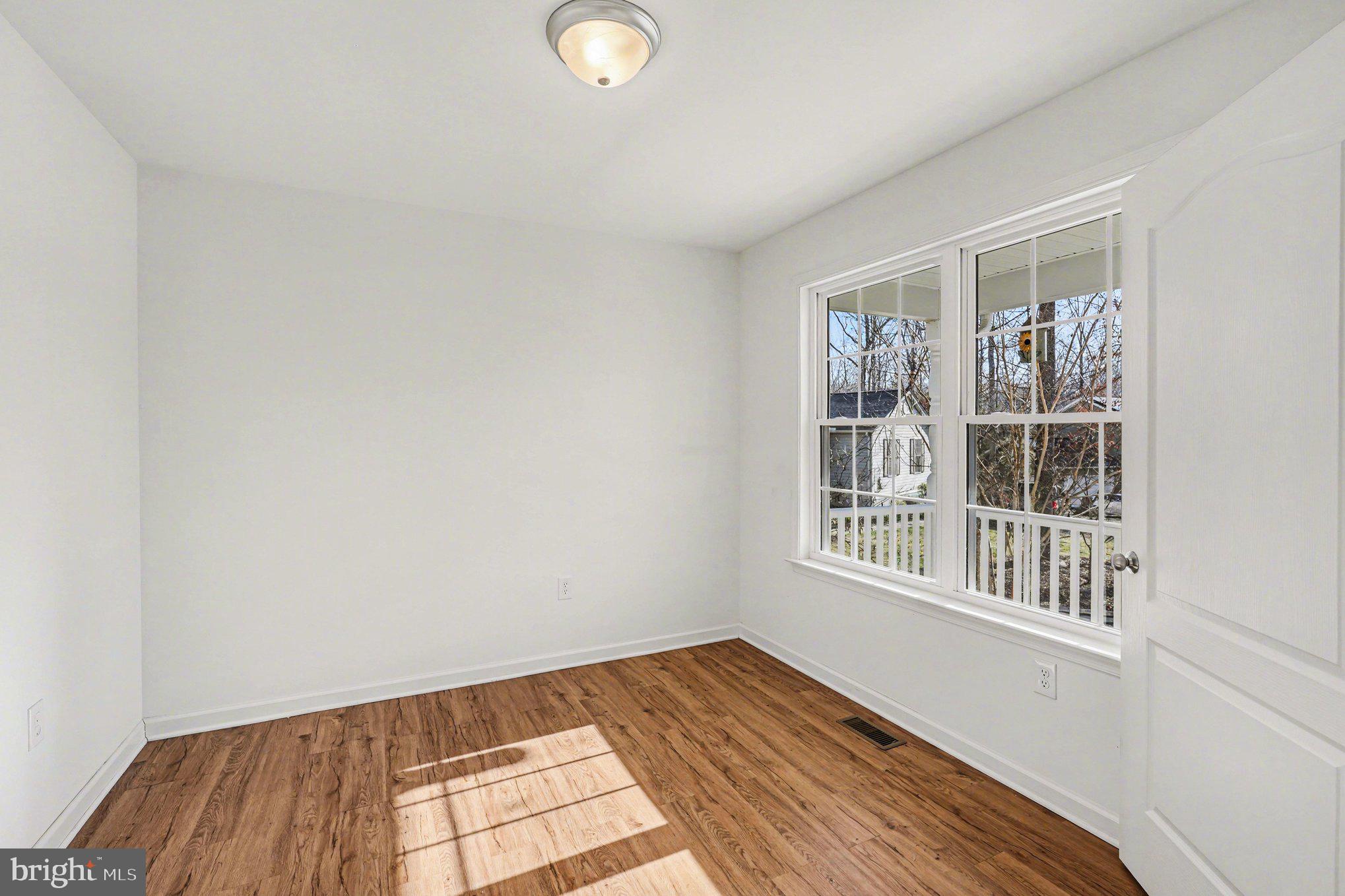 117 Butler Circle Locust Grove, VA 22508 - Photo 19 of 35 a view of an empty room with wooden floor and a window