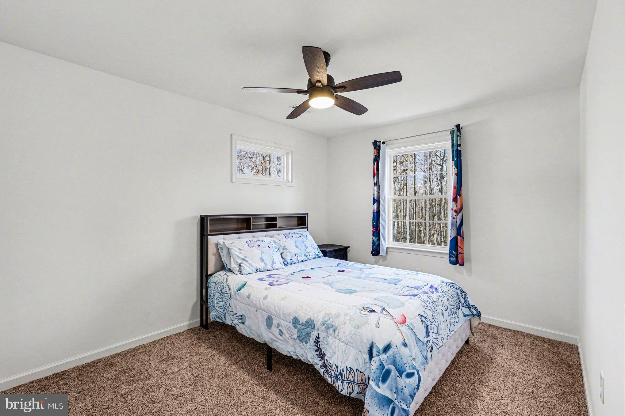 117 Butler Circle Locust Grove, VA 22508 - Photo 22 of 35 a bed sitting in a bedroom next to a window