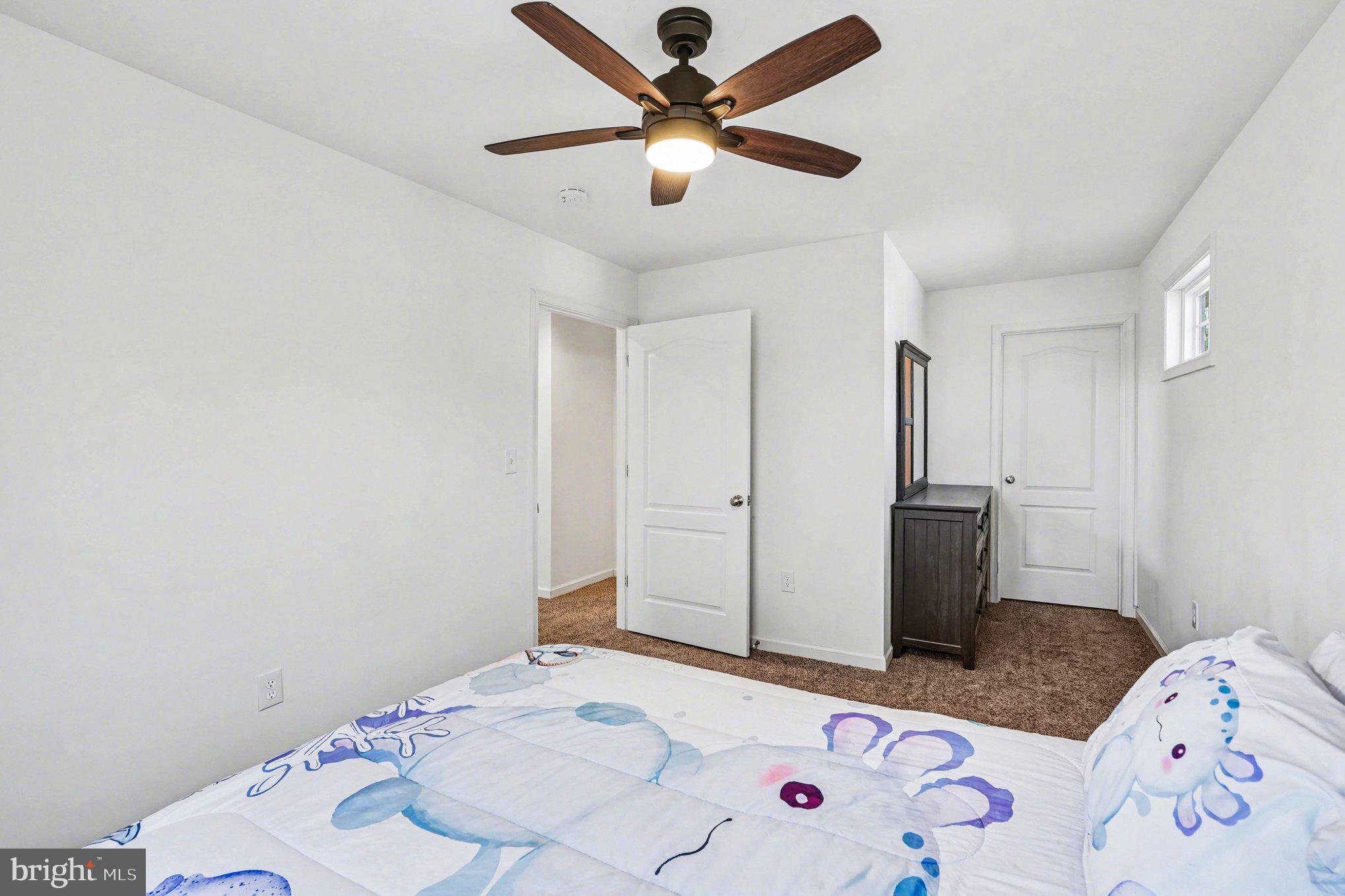 117 Butler Circle Locust Grove, VA 22508 - Photo 24 of 35 a bedroom with a bed and a chandelier