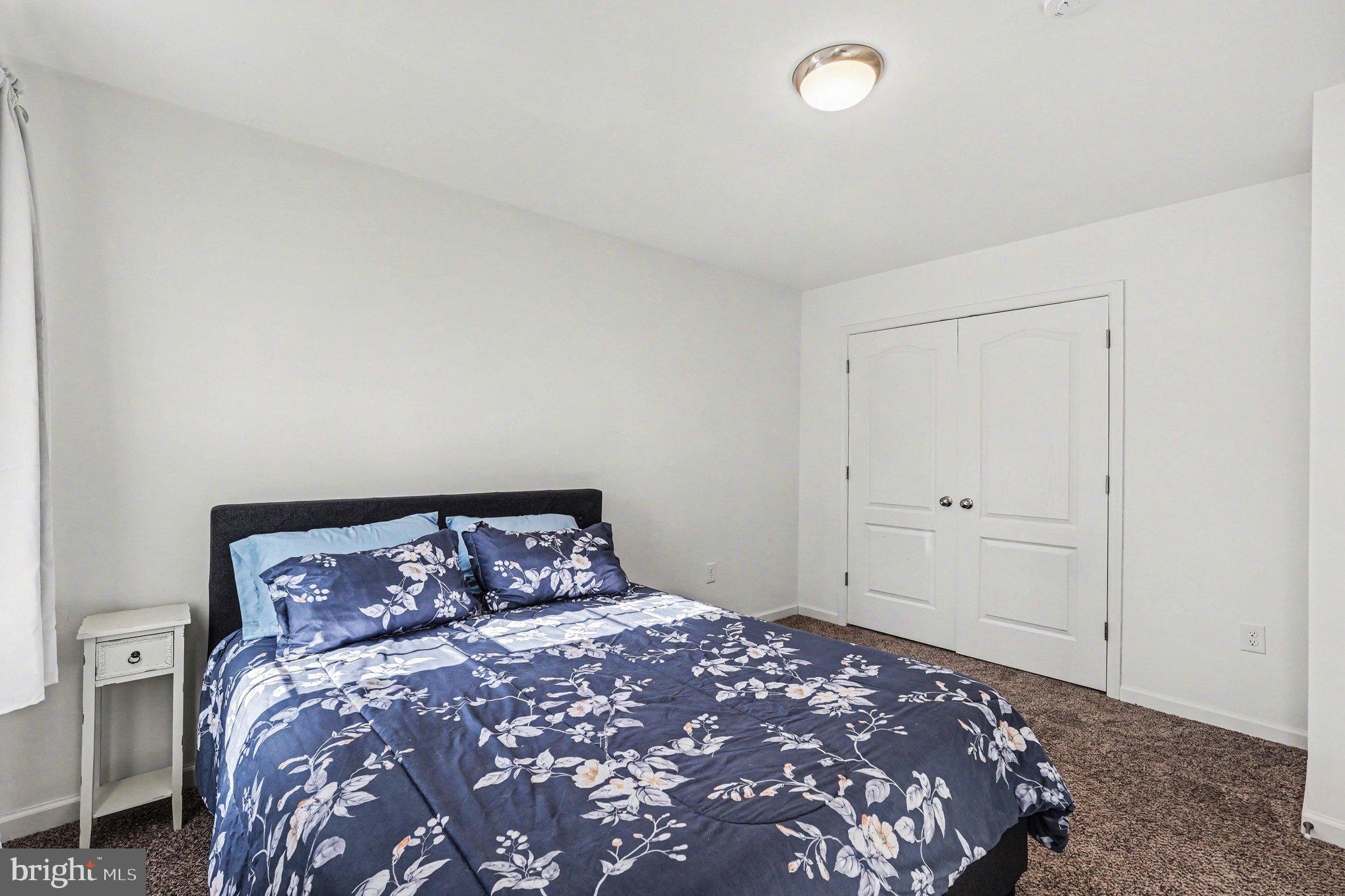 117 Butler Circle Locust Grove, VA 22508 - Photo 29 of 35 a bedroom with a large bed and a night stand