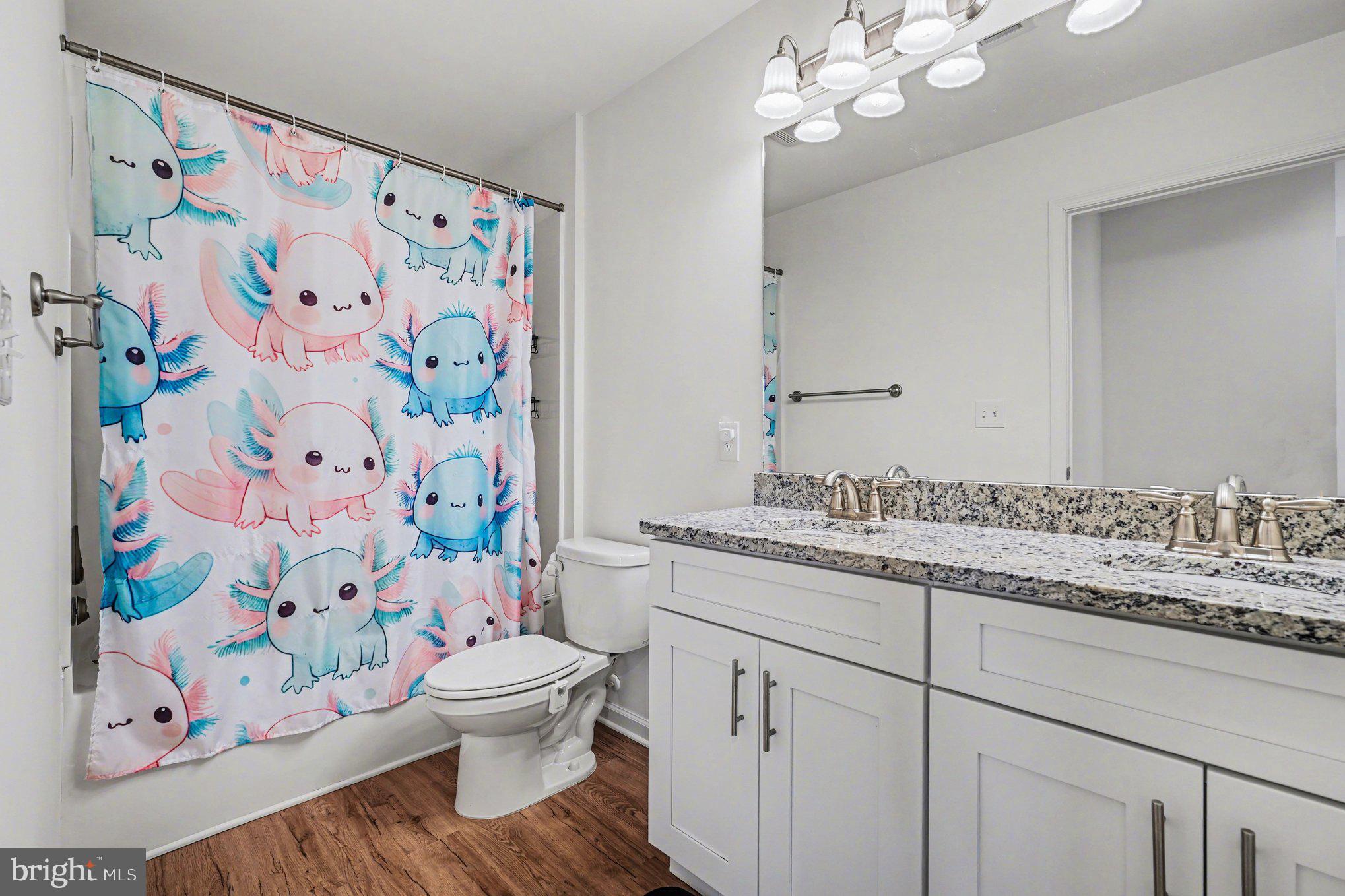 117 Butler Circle Locust Grove, VA 22508 - Photo 30 of 35 a bathroom with a granite countertop sink a toilet and a shower curtain
