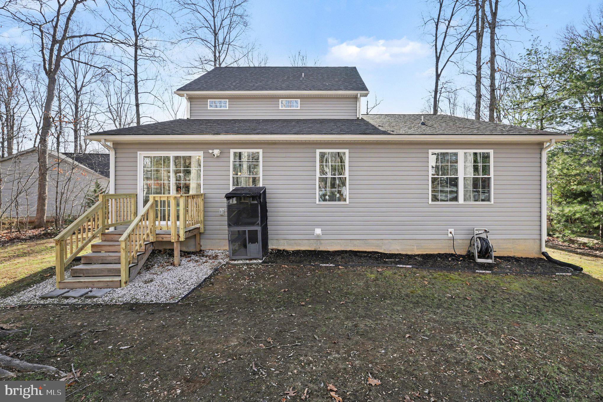 117 Butler Circle Locust Grove, VA 22508 - Photo 32 of 35 a view of a house with a yard and lawn chairs