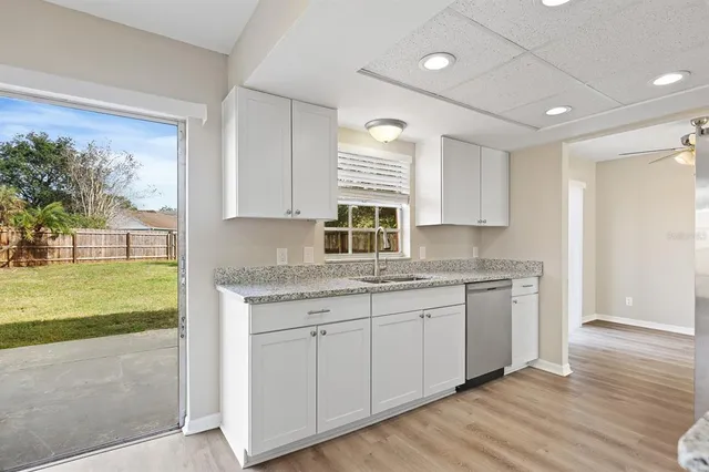 a kitchen with a sink cabinets and wooden floor