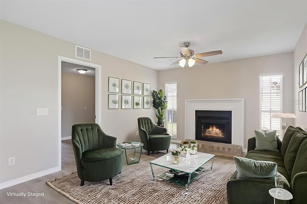 2107 Shady Point Lane Brandon, FL 33510 - Photo 13 of 38 a living room with furniture and a fireplace