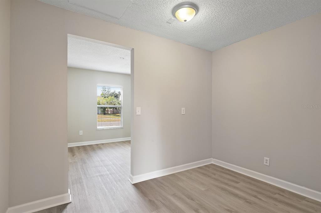 2107 Shady Point Lane Brandon, FL 33510 - Photo 16 of 38 an empty room with wooden floor and windows