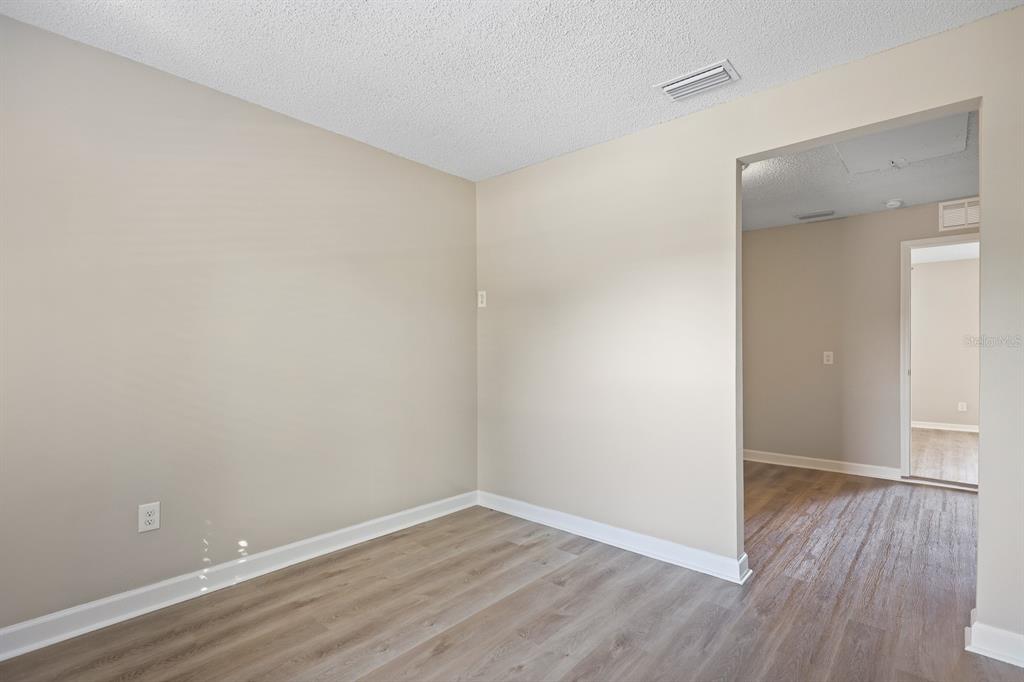 2107 Shady Point Lane Brandon, FL 33510 - Photo 17 of 38 a view of an empty room with wooden floor and closet