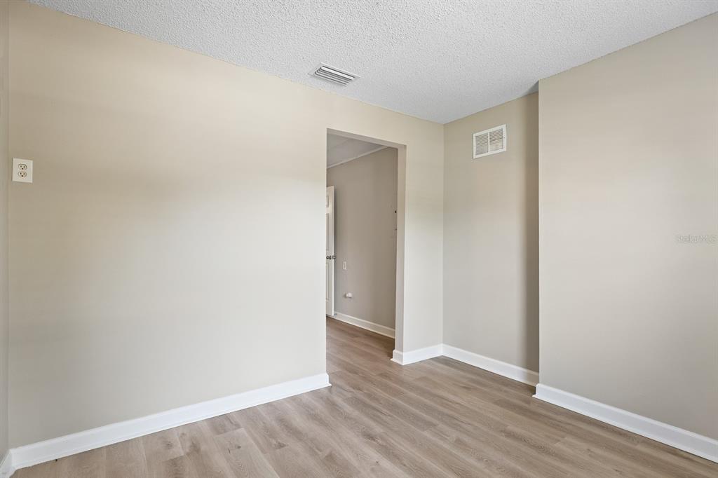 2107 Shady Point Lane Brandon, FL 33510 - Photo 18 of 38 a view of an empty room with wooden floor