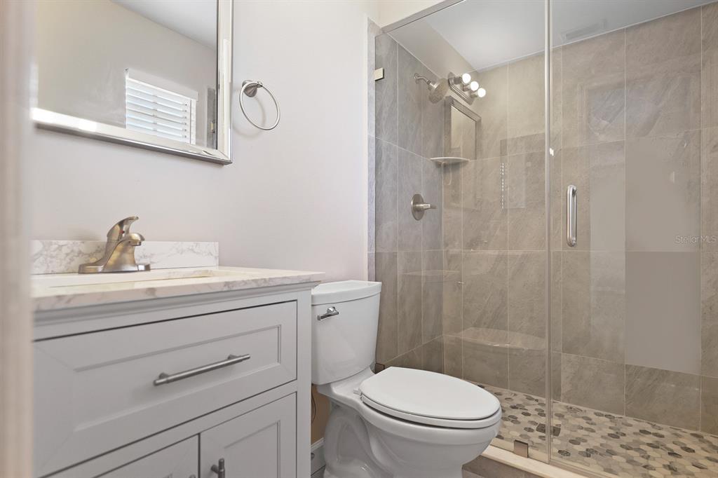 2107 Shady Point Lane Brandon, FL 33510 - Photo 24 of 38 a bathroom with a sink a toilet and shower