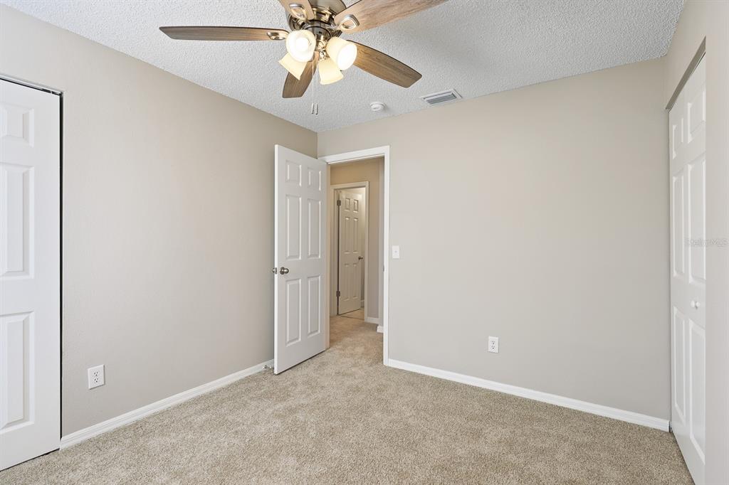 2107 Shady Point Lane Brandon, FL 33510 - Photo 26 of 38 an empty room with a fan and a fan