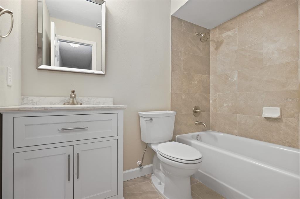 2107 Shady Point Lane Brandon, FL 33510 - Photo 27 of 38 a bathroom with a sink toilet and shower