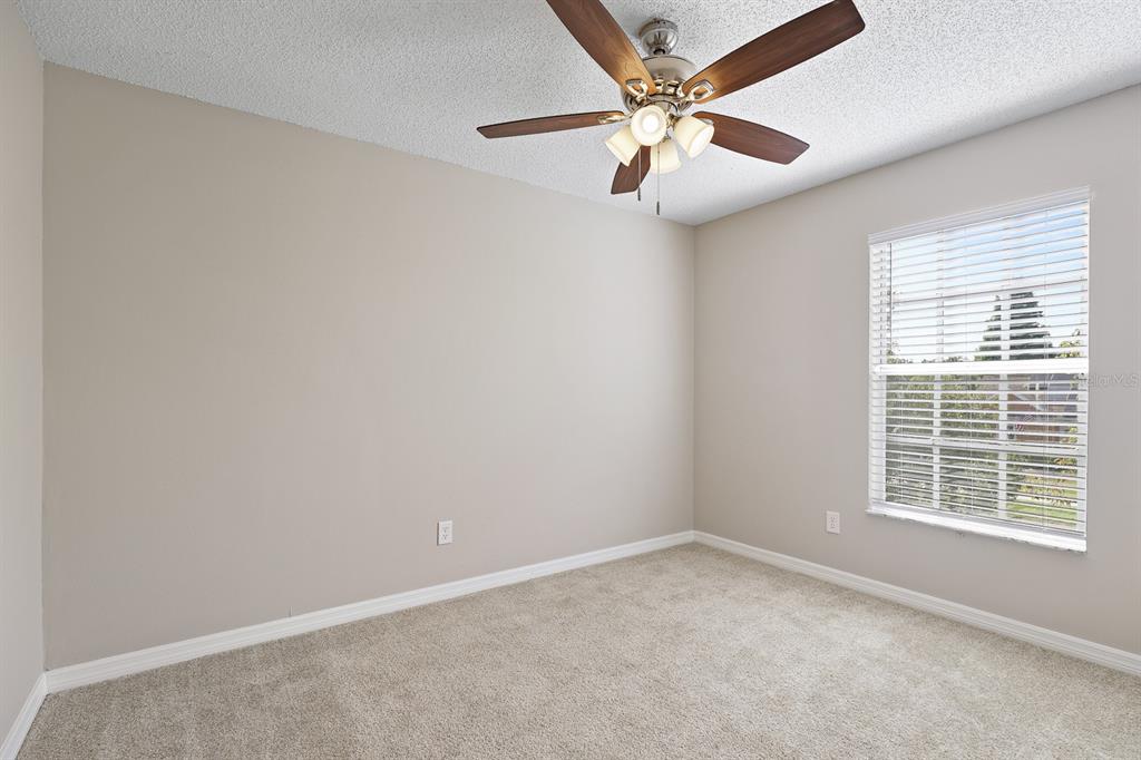2107 Shady Point Lane Brandon, FL 33510 - Photo 28 of 38 an empty room with windows and fan