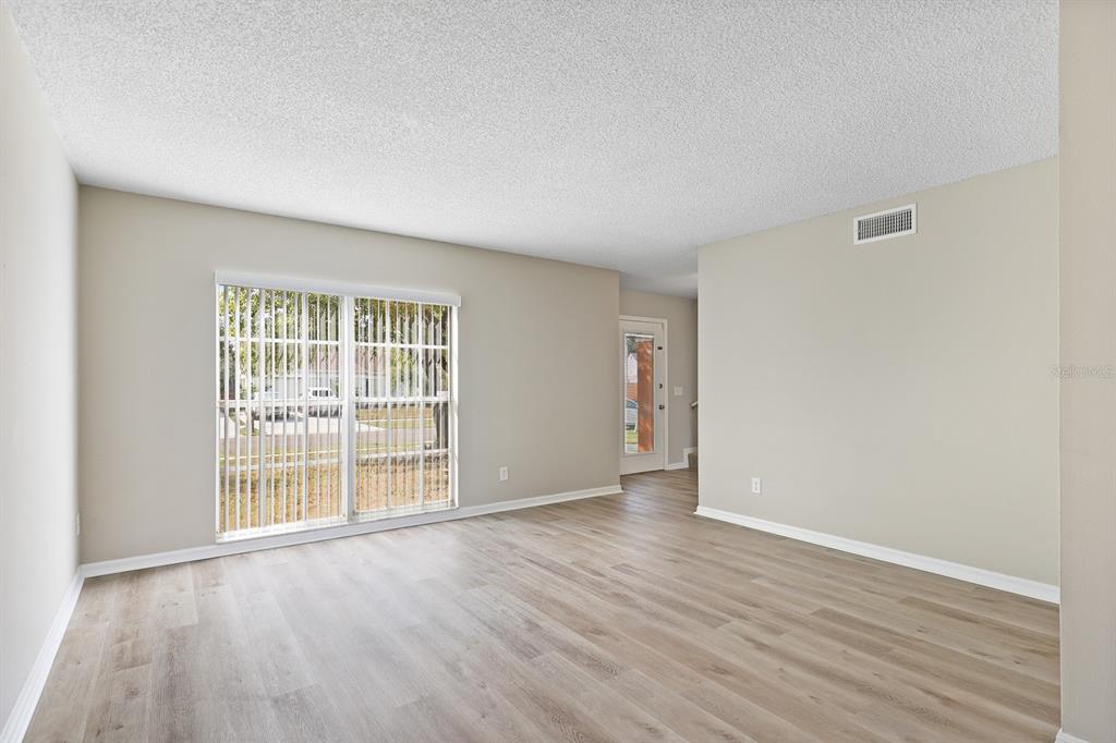 2107 Shady Point Lane Brandon, FL 33510 - Photo 5 of 38 wooden floor in an empty room with a window