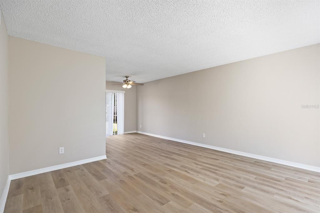 2107 Shady Point Lane Brandon, FL 33510 - Photo 7 of 38 a view of an empty room with wooden floor