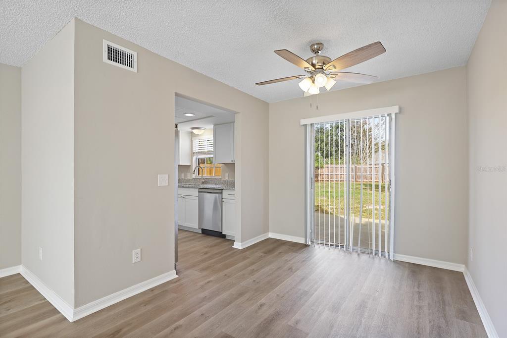 2107 Shady Point Lane Brandon, FL 33510 - Photo 9 of 38 a view of a livingroom with a ceiling fan hardwood floor and a ceiling fan