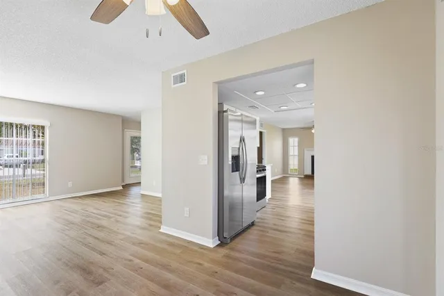 a view of a hallway with wooden floor