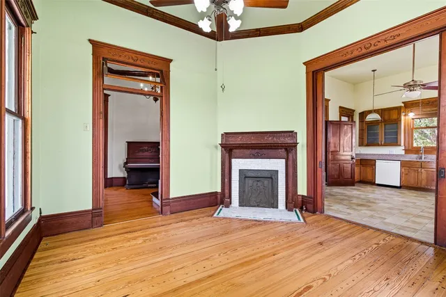 a view of a livingroom with a fireplace and wooden floor