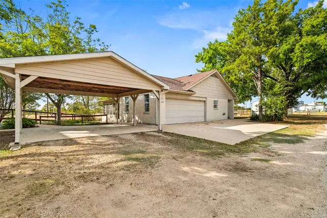 a view of a house with a yard and garage