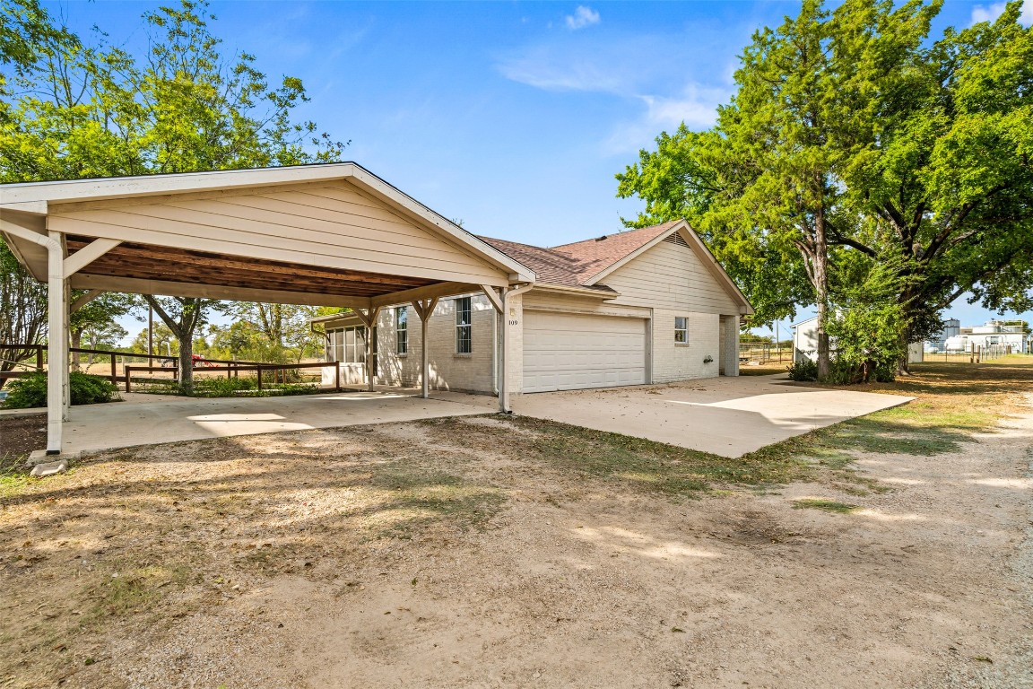 105 Davis Drive Thorndale, TX 76577 - Photo 22 of 40 a view of a house with a yard and garage