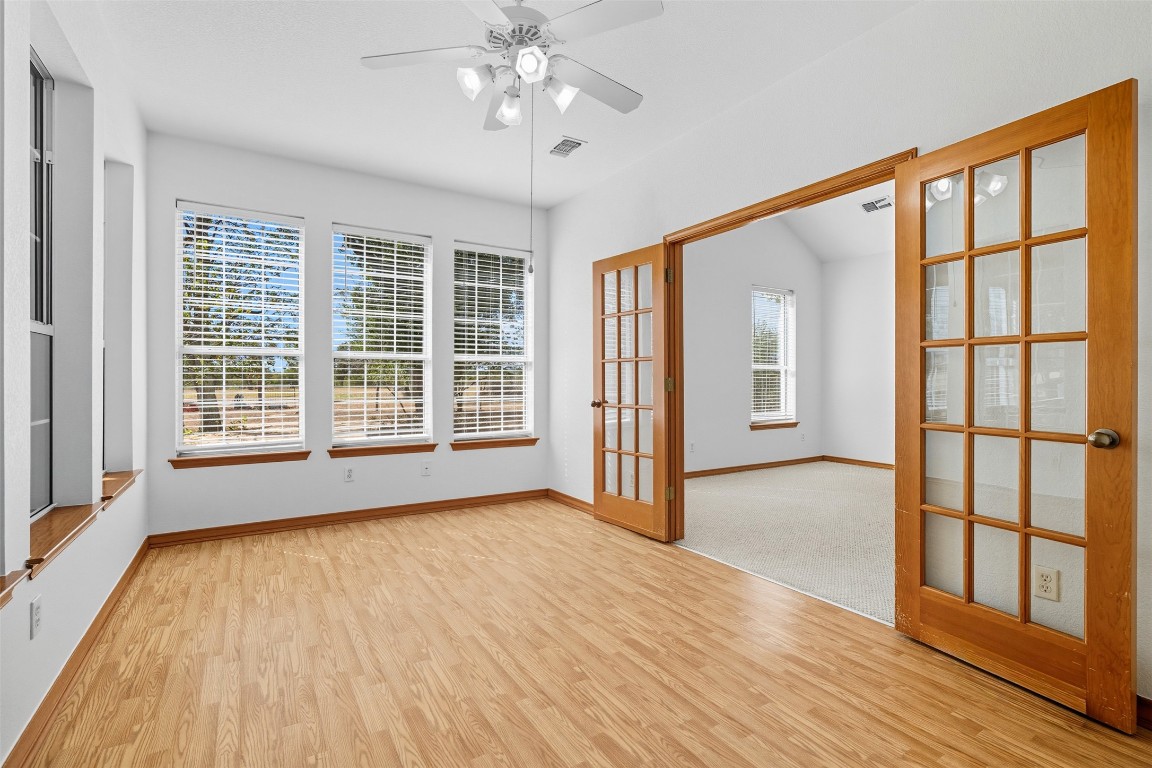 105 Davis Drive Thorndale, TX 76577 - Photo 26 of 40 a view of an empty room with wooden floor and a window