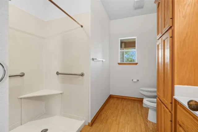 a bathroom with a tub and toilet