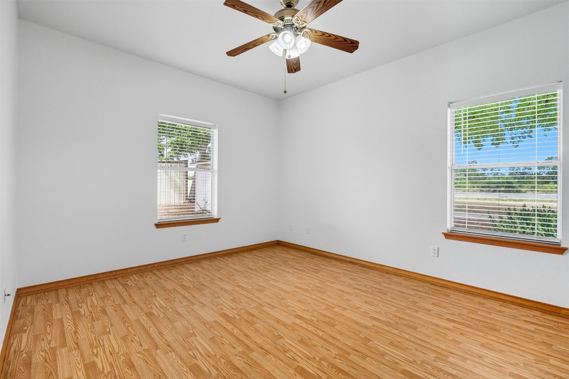 105 Davis Drive Thorndale, TX 76577 - Photo 30 of 40 a view of an empty room with a window and wooden floor