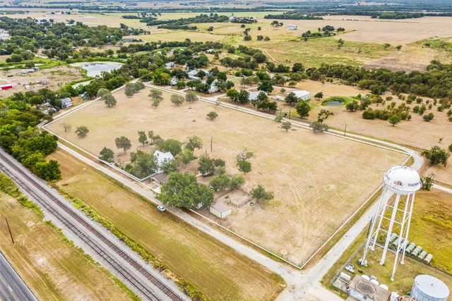 a view of a swimming pool with a lawn chairs and wooden floor
