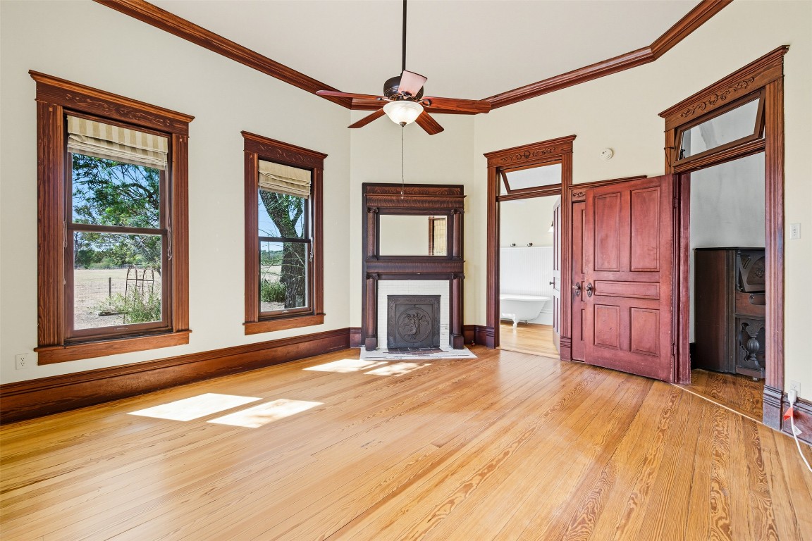 105 Davis Drive Thorndale, TX 76577 - Photo 10 of 40 a view of an empty room with wooden floor fireplace and a window