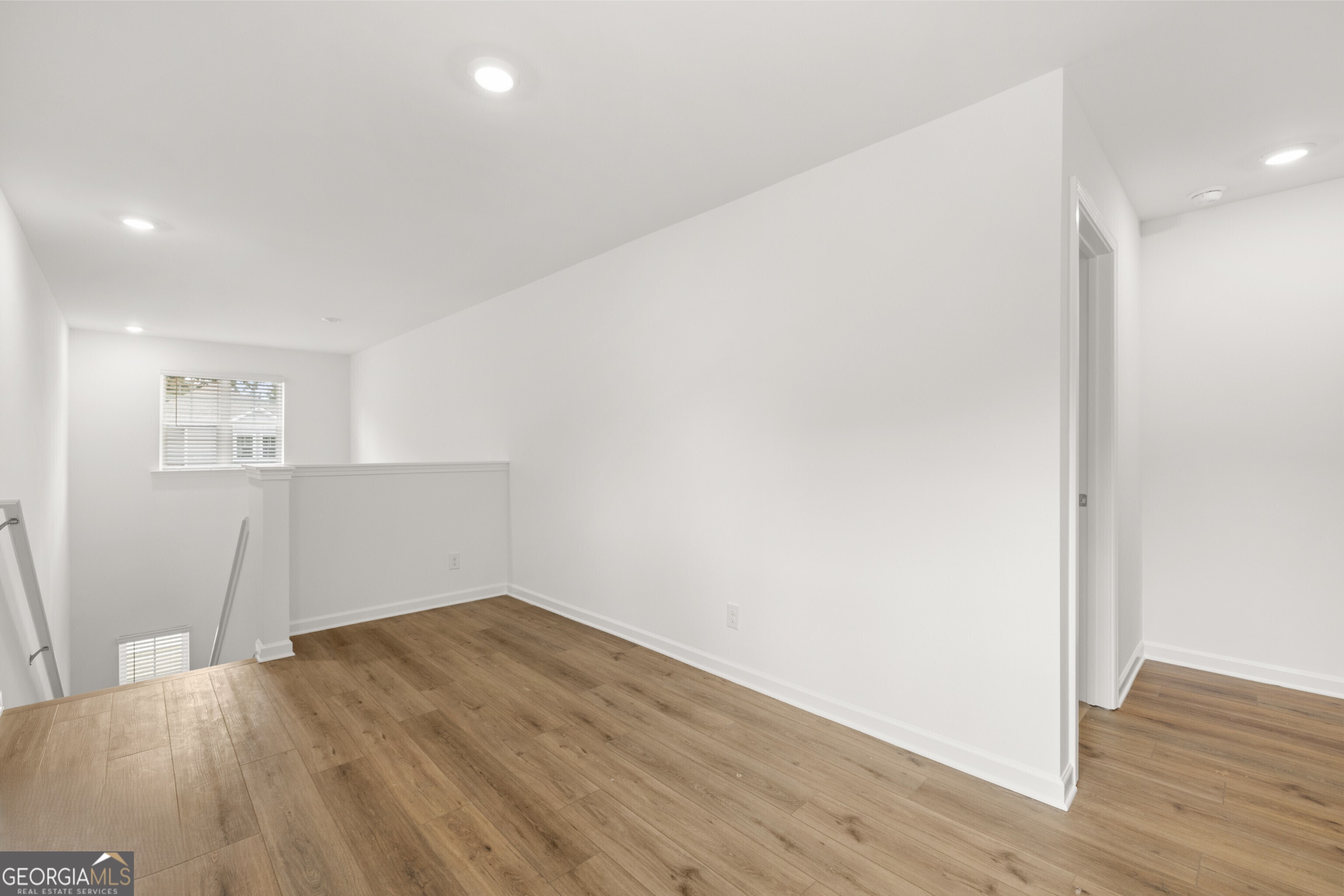 2464 Lennox Road Southeast Conyers, GA 30094 - Photo 16 of 27 a view of empty room with wooden floor