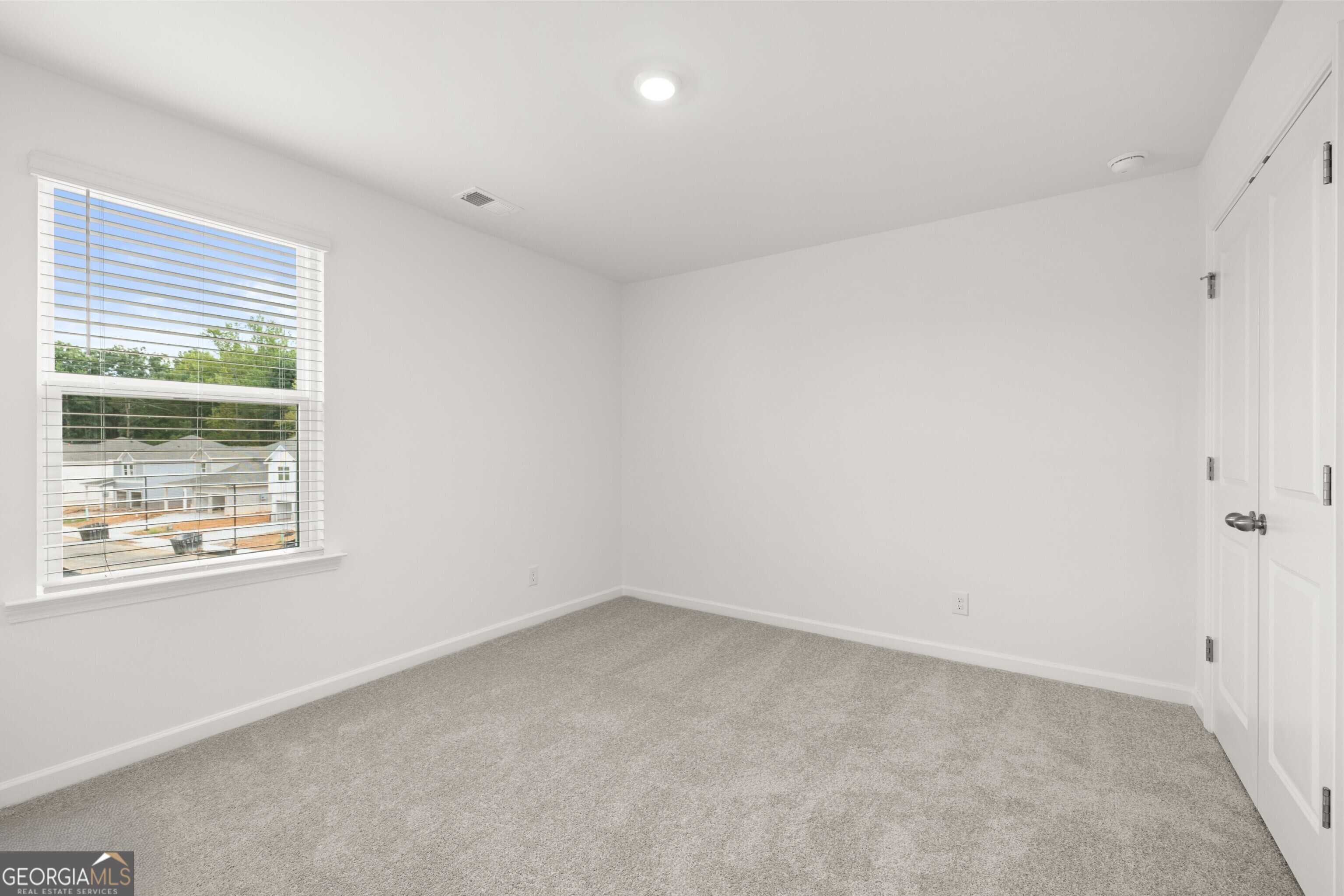 2464 Lennox Road Southeast Conyers, GA 30094 - Photo 19 of 27 an empty room with a window