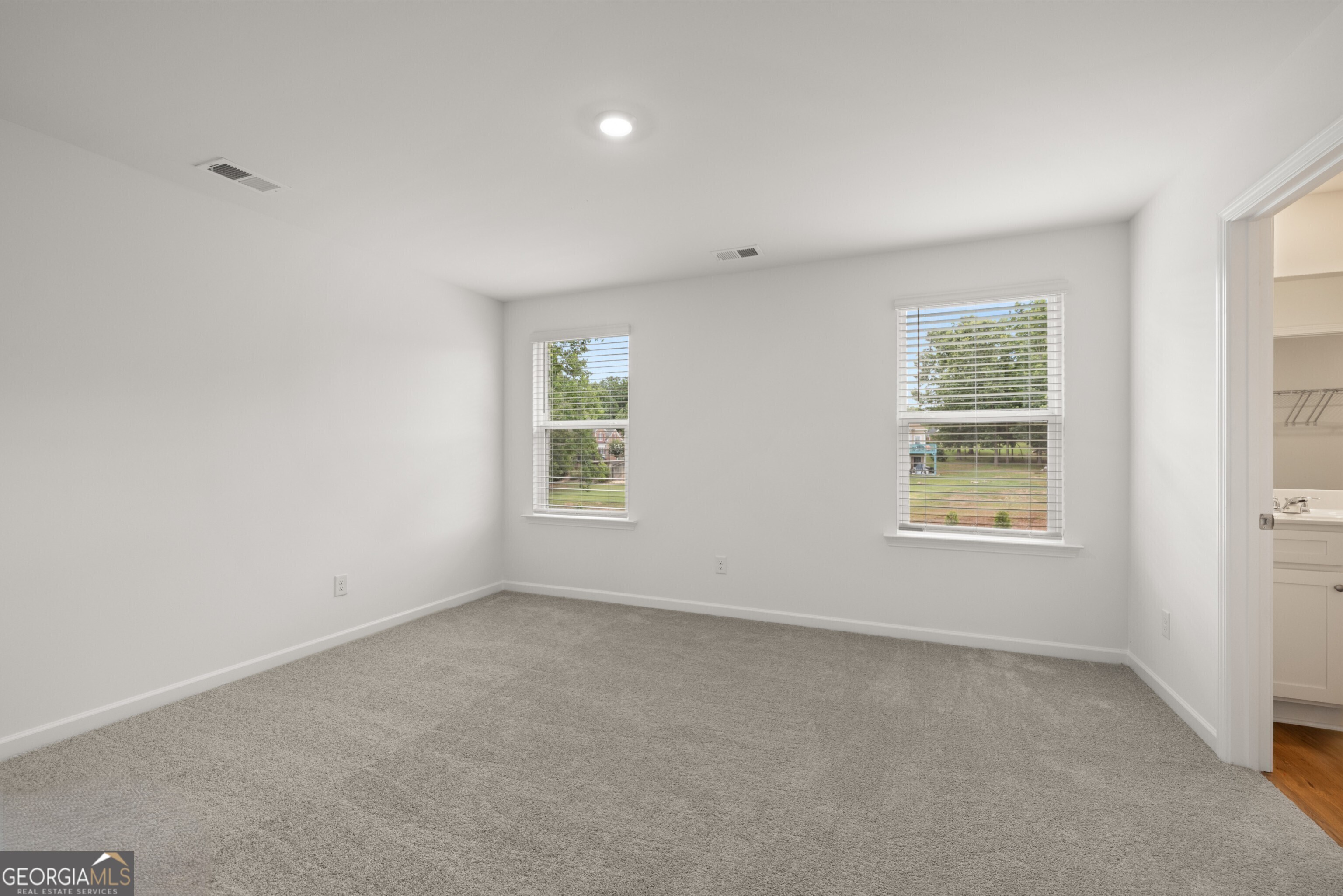 2464 Lennox Road Southeast Conyers, GA 30094 - Photo 20 of 27 an empty room with windows