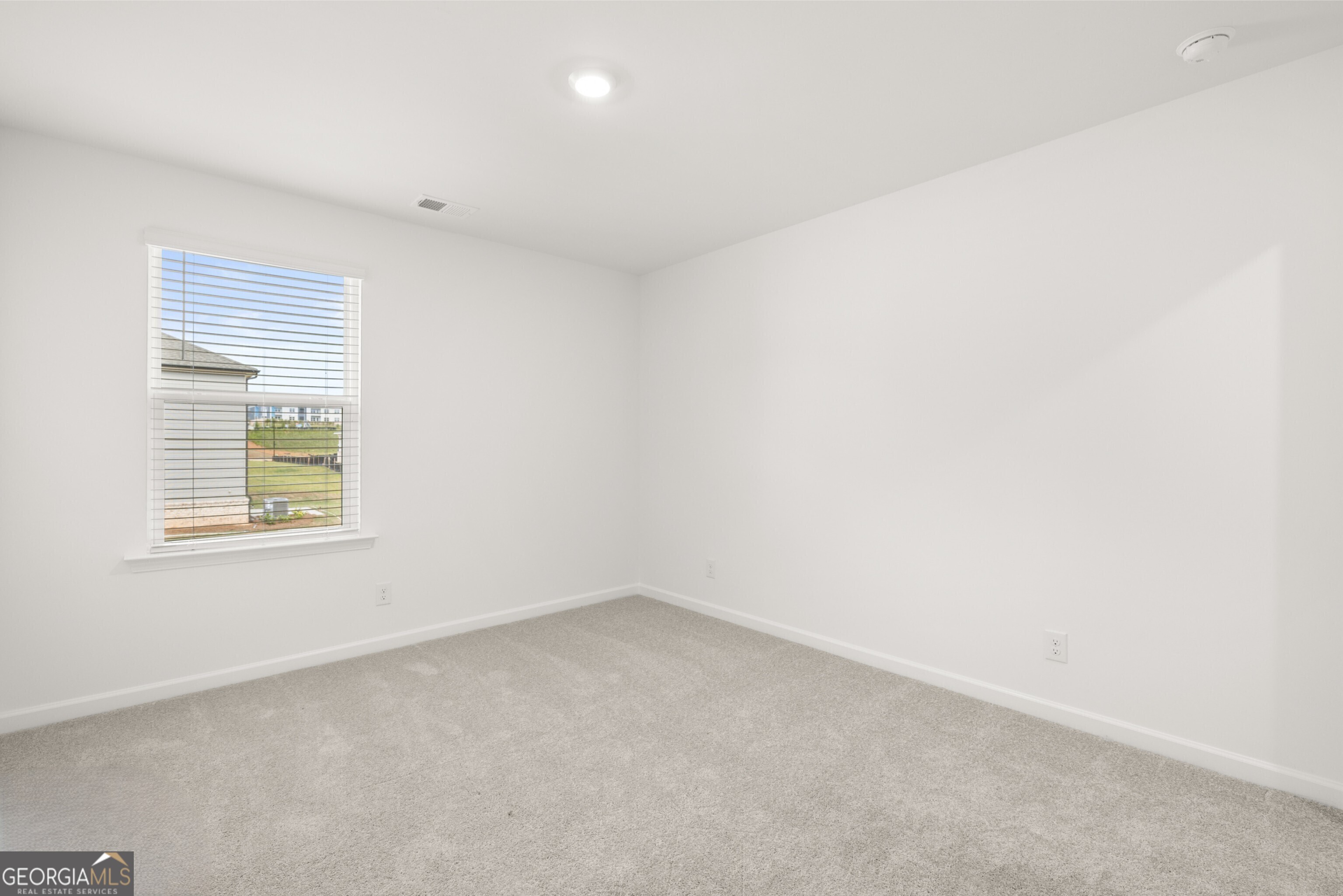 2464 Lennox Road Southeast Conyers, GA 30094 - Photo 22 of 27 an empty room with a window