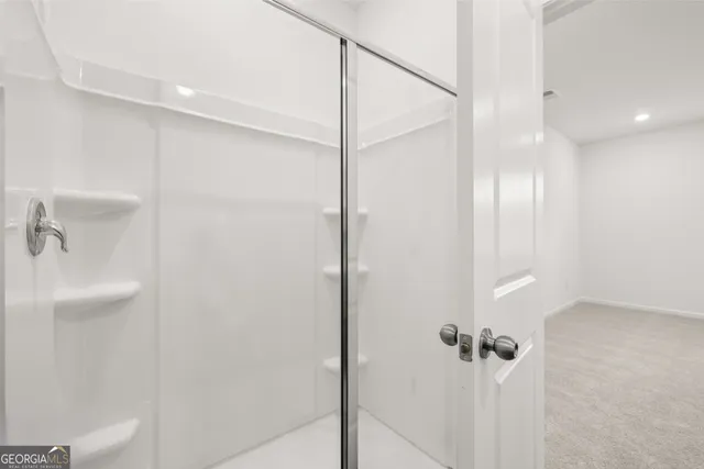 a bathroom with a shower and a toilet
