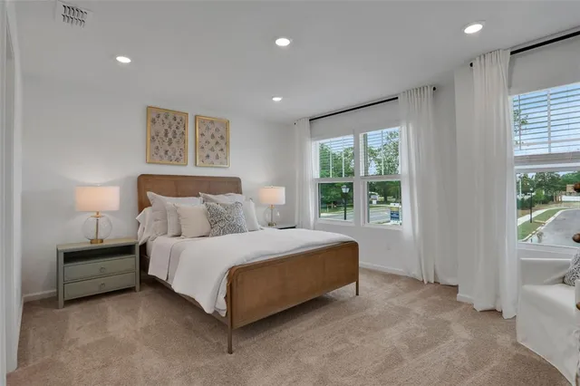 a spacious bedroom with a bed and a large window