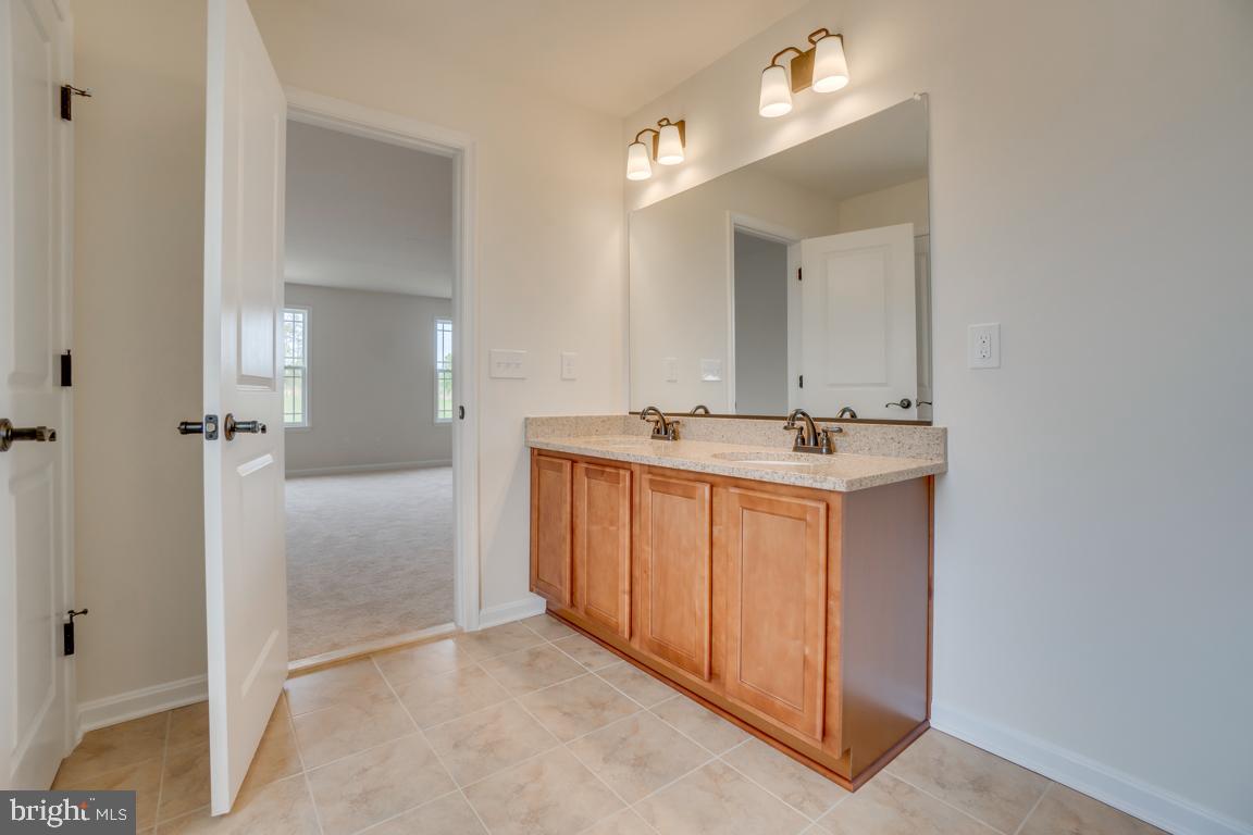 0 Latane Drive Colonial Beach, VA 22443 - Photo 28 of 38 Primary bath w/ dual vanity, warm cabinets