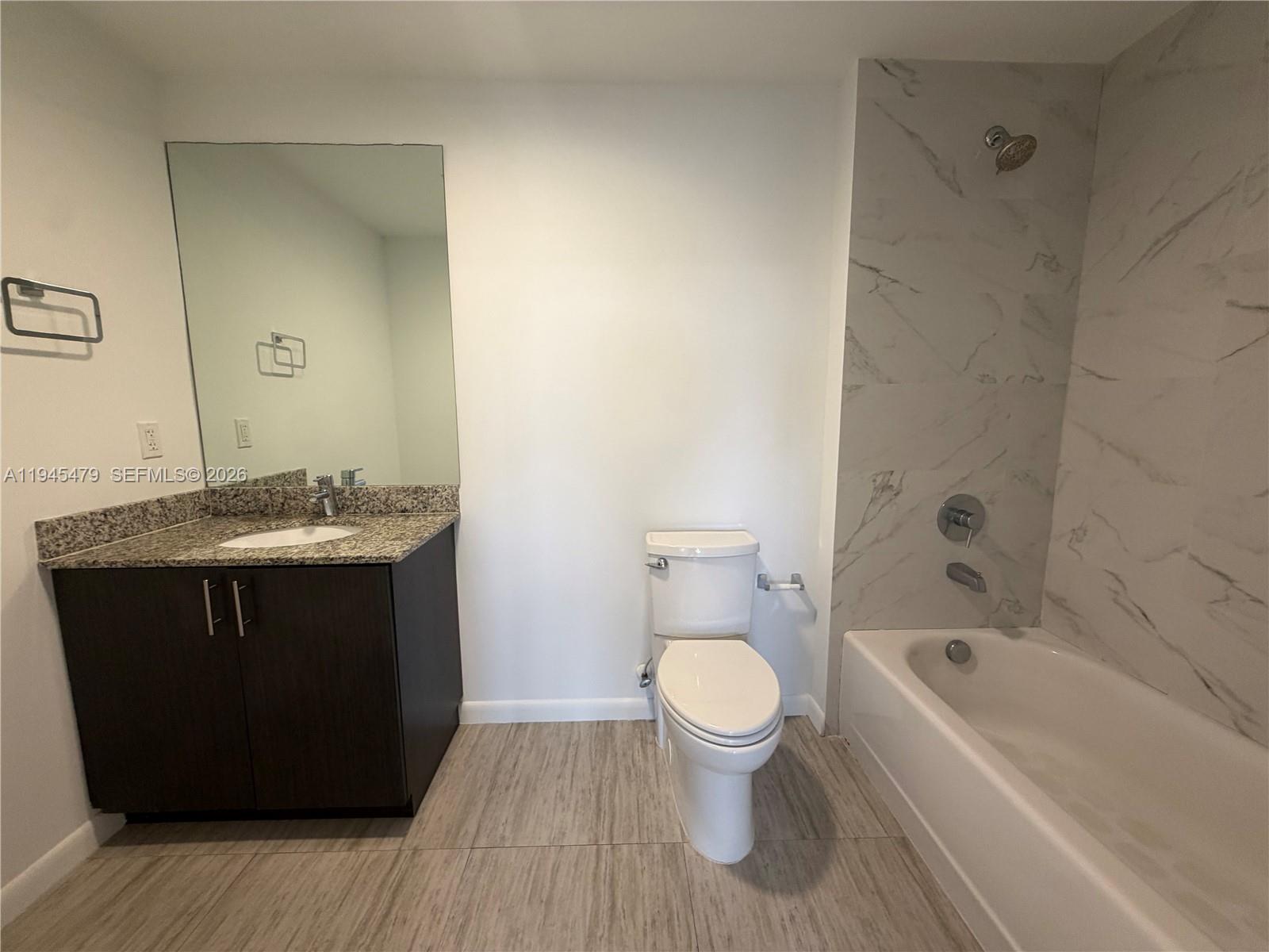 1801 Southwest 32nd Avenue, Unit 701 Miami, FL 33145 - Photo 11 of 13 a bathroom with a sink toilet and shower