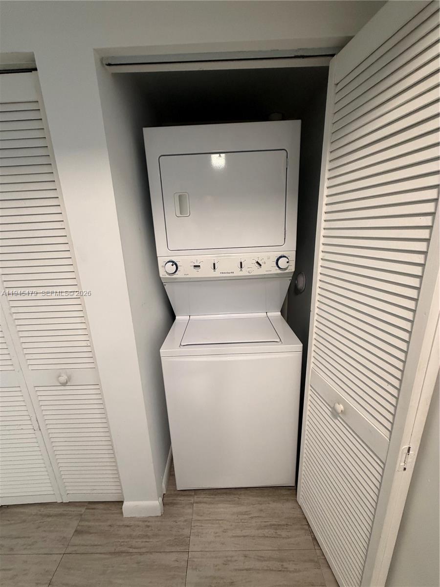 1801 Southwest 32nd Avenue, Unit 701 Miami, FL 33145 - Photo 13 of 13 a utility room with wooden floor washer and dryer