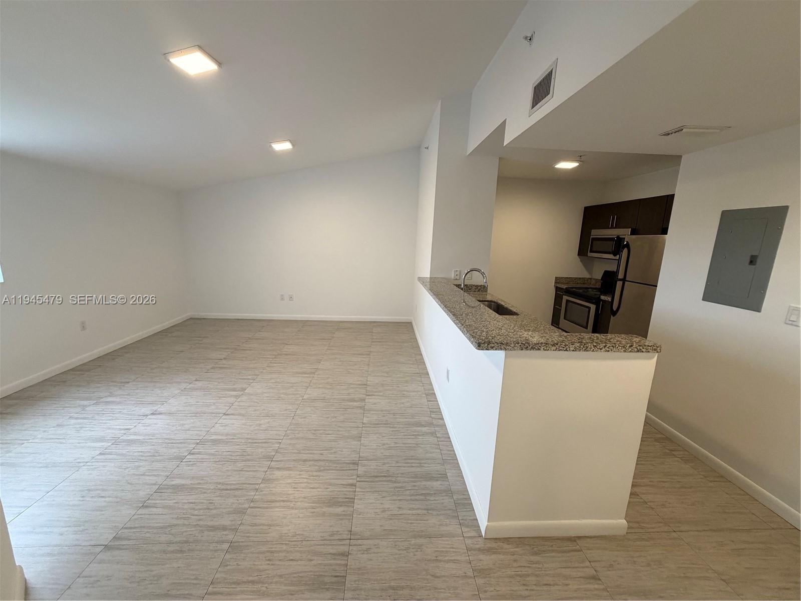 1801 Southwest 32nd Avenue, Unit 701 Miami, FL 33145 - Photo 3 of 13 a living room with couches and kitchen view