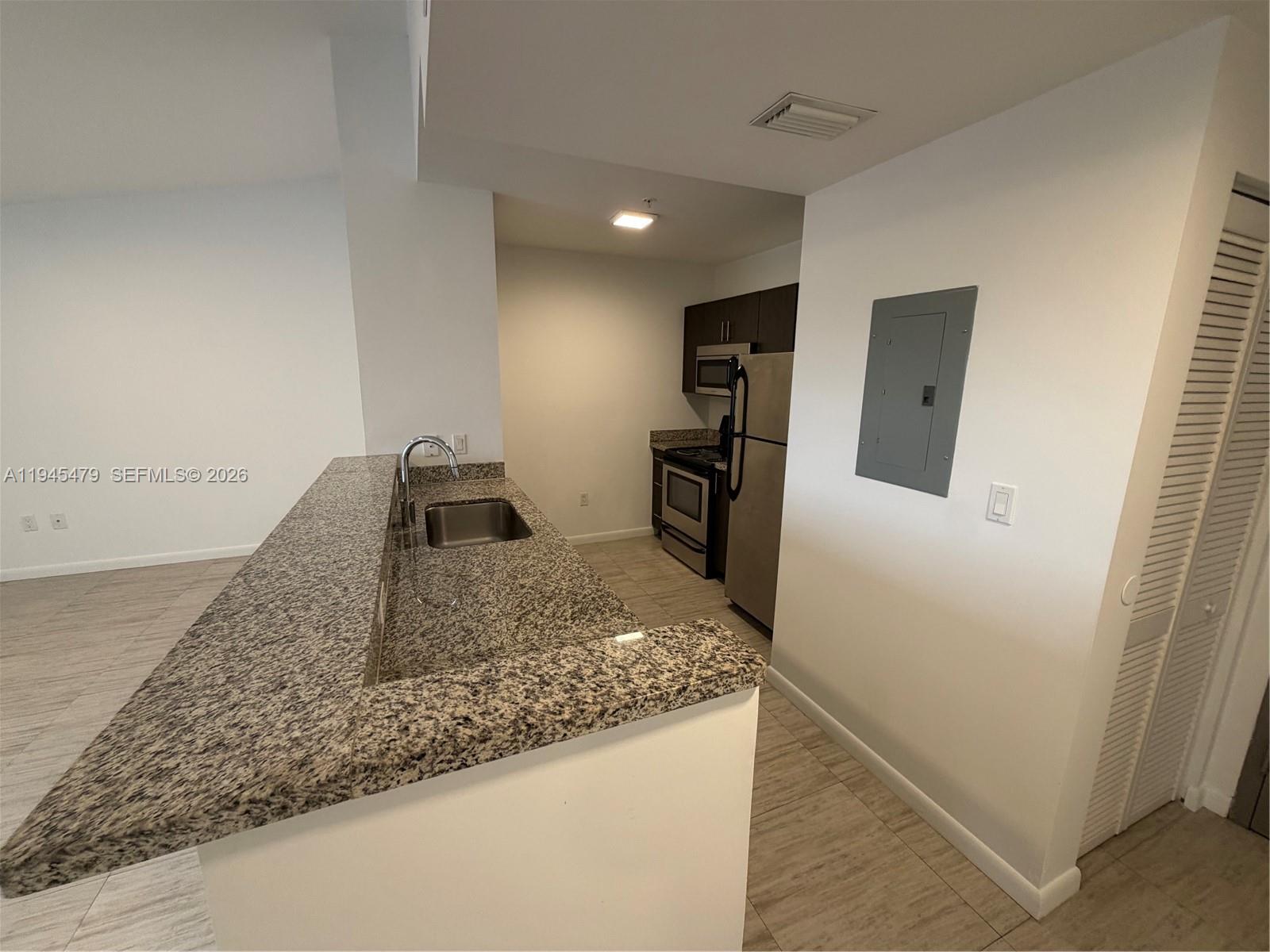 1801 Southwest 32nd Avenue, Unit 701 Miami, FL 33145 - Photo 4 of 13 a view of a kitchen cabinets