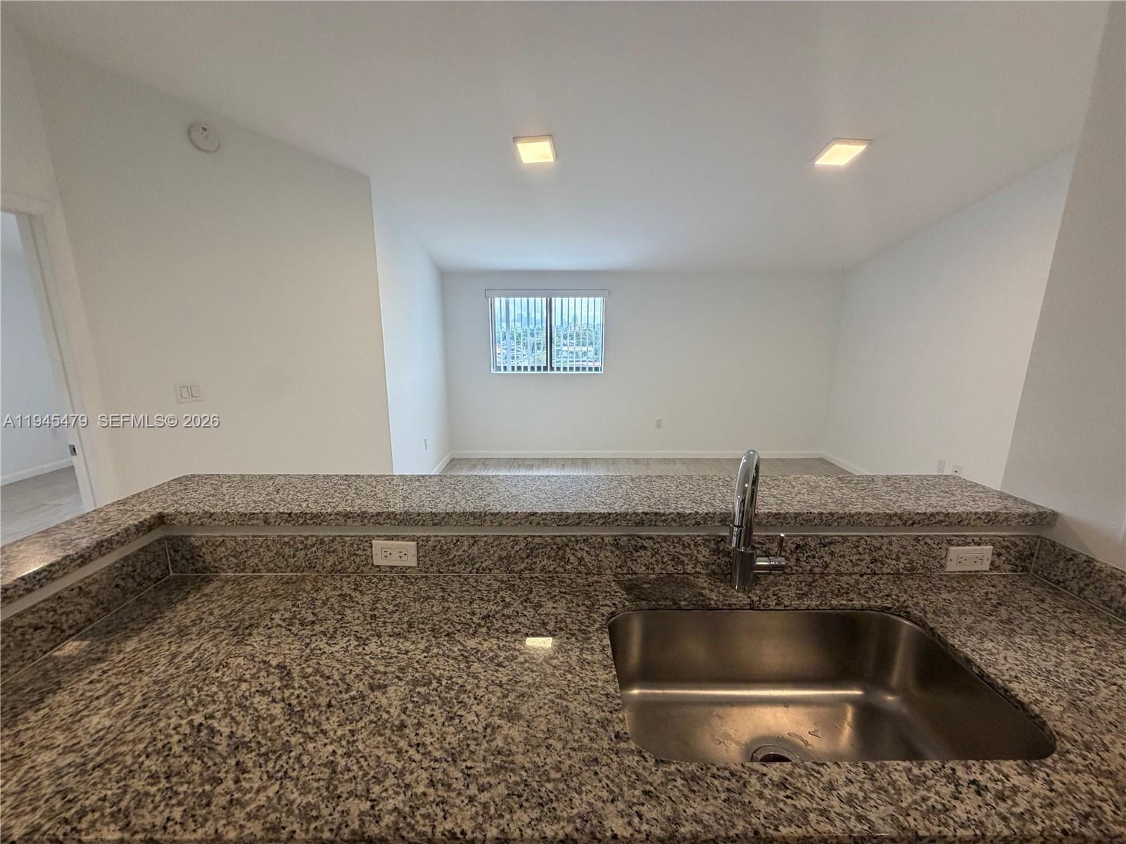 1801 Southwest 32nd Avenue, Unit 701 Miami, FL 33145 - Photo 8 of 13 a kitchen with a sink and granite top