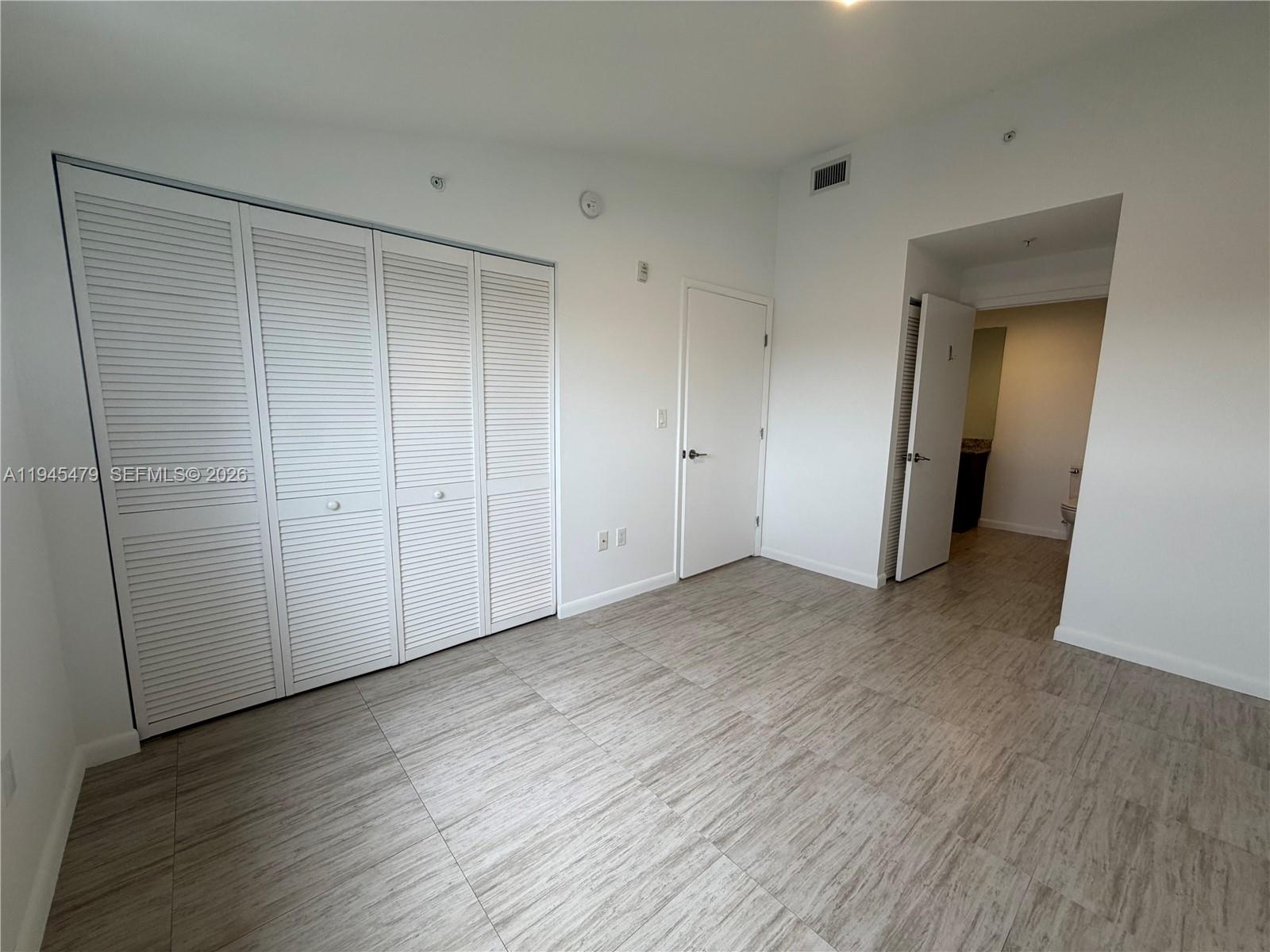 1801 Southwest 32nd Avenue, Unit 701 Miami, FL 33145 - Photo 10 of 13 a view of an empty room with wooden floor