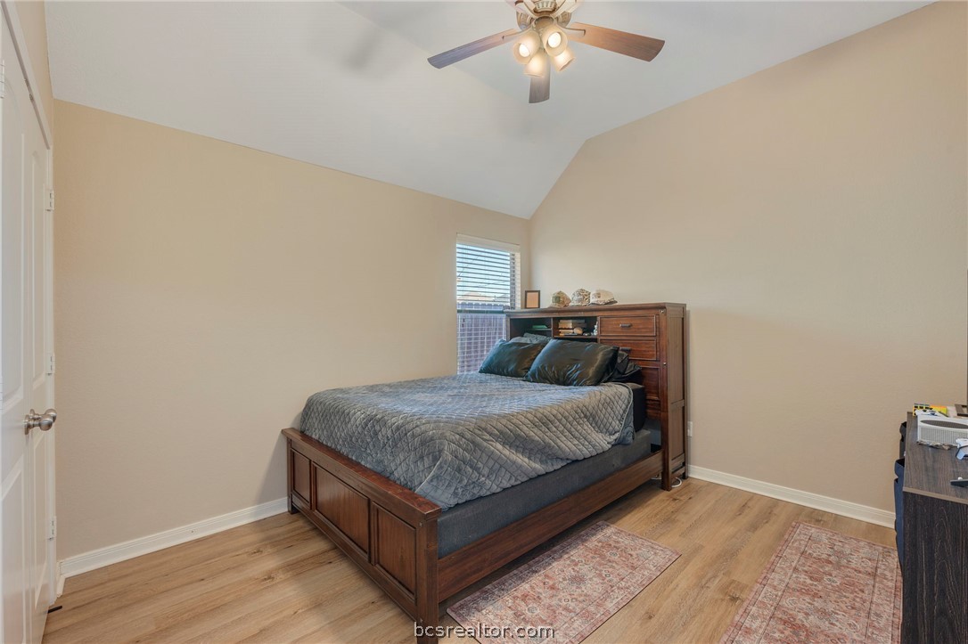 2000 Turning Leaf Drive Bryan, TX 77807 - Photo 11 of 20 a bedroom with a bed and a chandelier