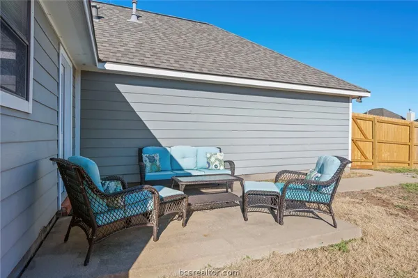 a roof deck with a table and chairs
