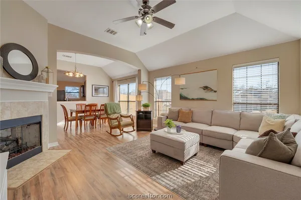 a living room with furniture a fireplace dining table and a fireplace