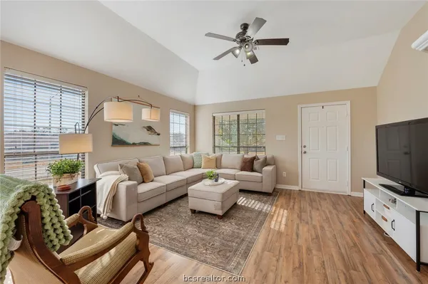 a living room with furniture and a flat screen tv