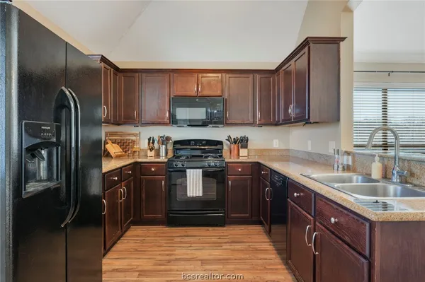 a kitchen with a sink stove and refrigerator