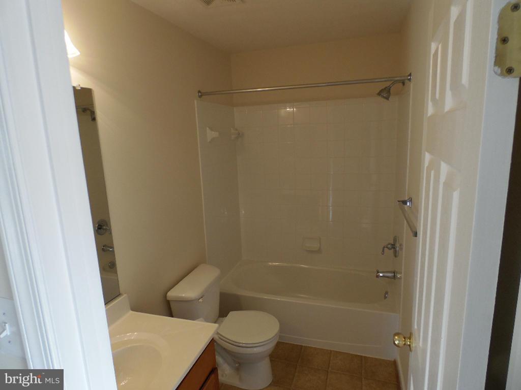 9705 Langley Road Baltimore, MD 21220 - Photo 18 of 26 a bathroom with a shower and a toilet