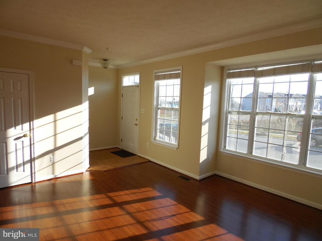 9705 Langley Road Baltimore, MD 21220 - Photo 3 of 26 a view of an empty room with wooden floor and a window