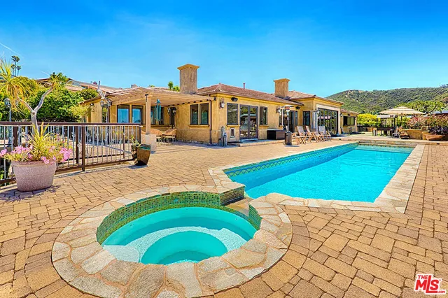 a swimming pool with outdoor seating yard and barbeque oven