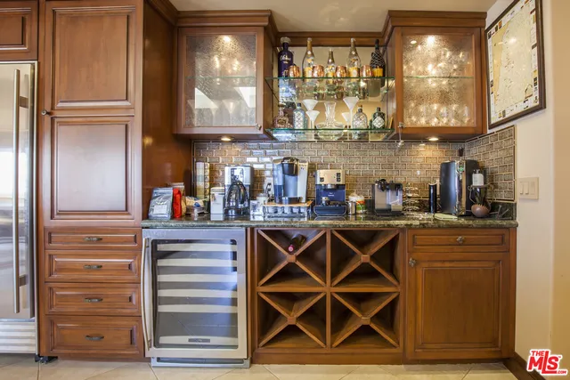 a view of a refrigerator with wooden cabinets