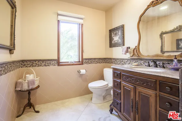 a spacious bathroom with a toilet sink and mirror